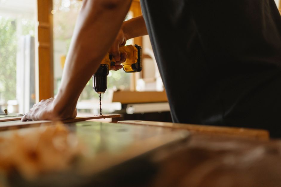 Carpenter carefully installing custom kitchen cabinets